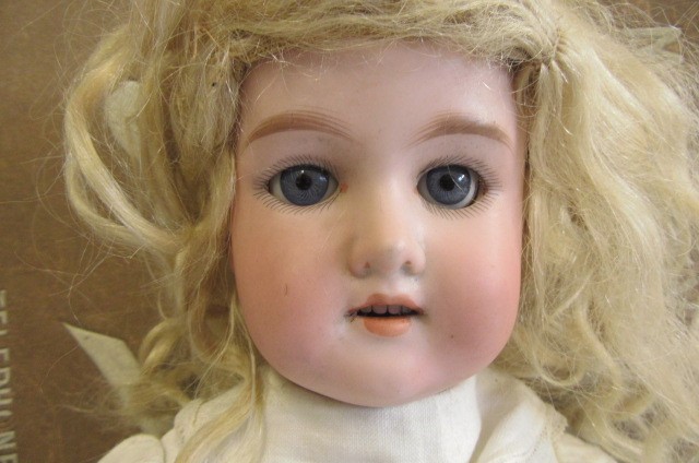 An Armand Marseille Floradora bisque socket head doll Image