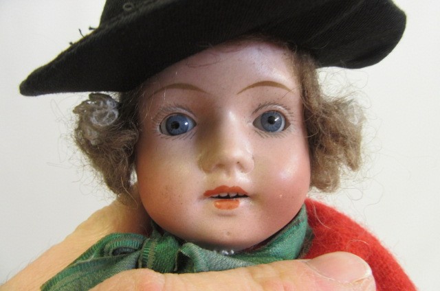 A collection of twelve small dolls including a Herman Steiner bisque socket head doll Image