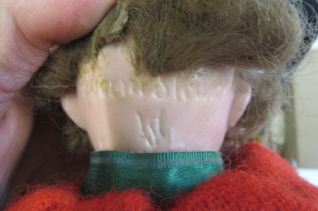 A collection of twelve small dolls including a Herman Steiner bisque socket head doll Image