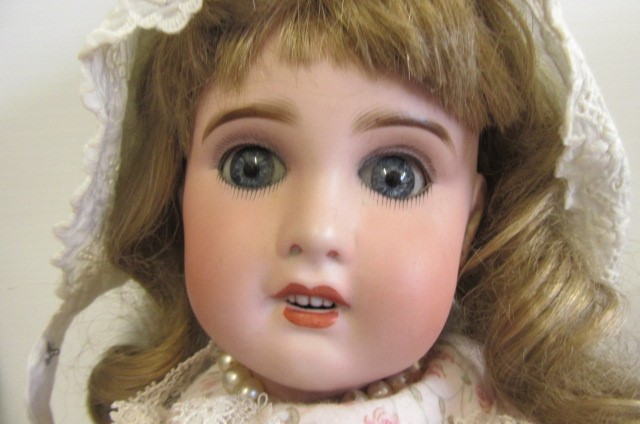 An S.F.B.J. bisque socket head doll with blue glass sleeping eyes Image