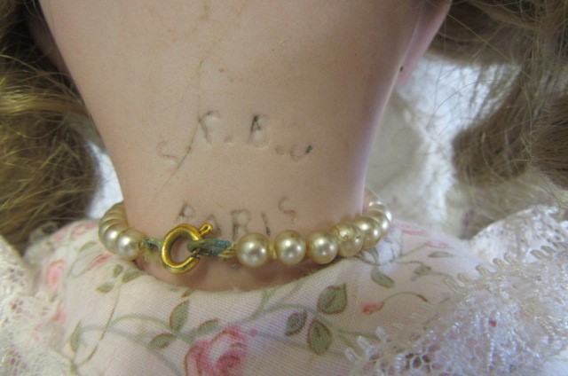 An S.F.B.J. bisque socket head doll with blue glass sleeping eyes Image