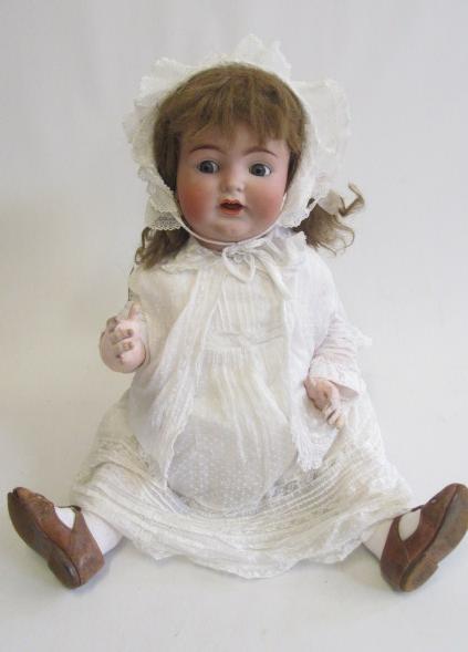 A Kammer & Reinhardt bisque socket head character doll with blue glass flirty eyes Image