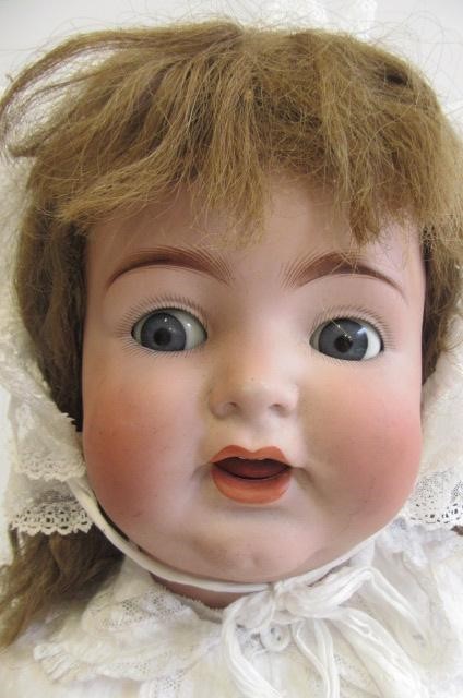 A Kammer & Reinhardt bisque socket head character doll with blue glass flirty eyes Image