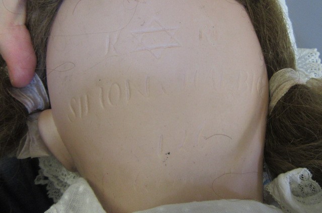 A Kammer & Reinhardt bisque socket head character doll with blue glass flirty eyes Image