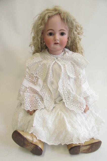 A Kammer & Reinhardt bisque socket head doll with brown glass sleeping eyes Image