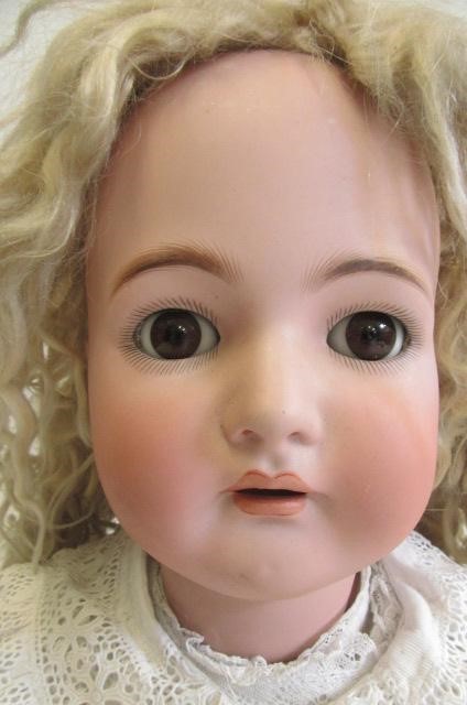 A Kammer & Reinhardt bisque socket head doll with brown glass sleeping eyes Image