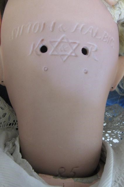 A Kammer & Reinhardt bisque socket head doll with brown glass sleeping eyes Image