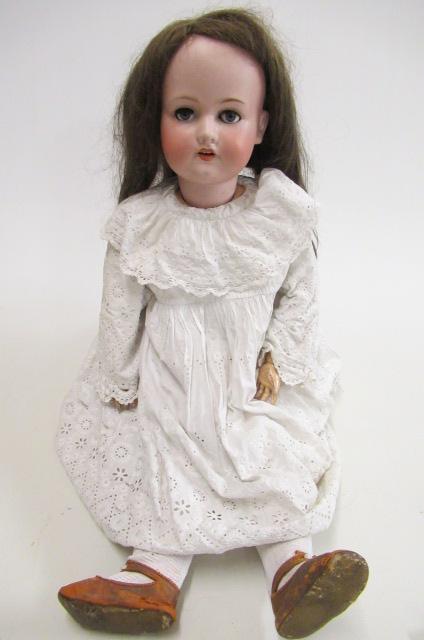 An Armand Marseille bisque socket doll with blue glass sleeping eyes Image