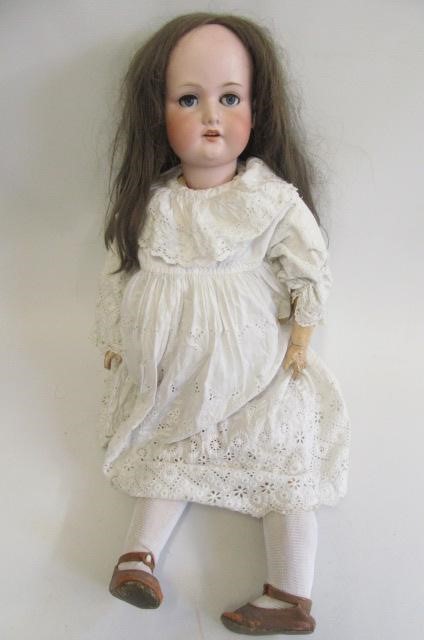 An Armand Marseille bisque socket doll with blue glass sleeping eyes Image