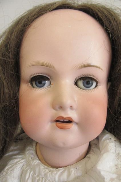 An Armand Marseille bisque socket doll with blue glass sleeping eyes Image