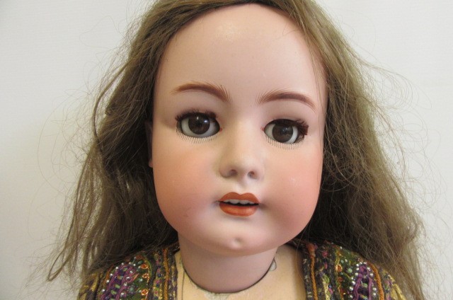 A large Simon & Halbig bisque socket head doll with brown glass sleeping eyes Image