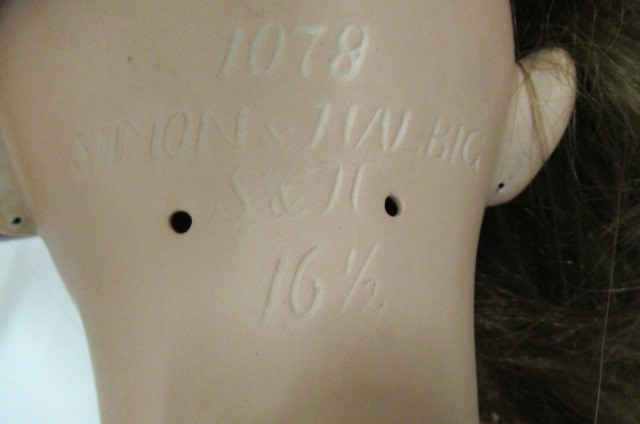 A large Simon & Halbig bisque socket head doll with brown glass sleeping eyes Image