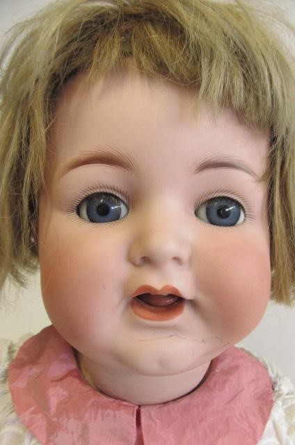 A Kammer & Reinhardt bisque socket head character doll with blue glass paperweight sleeping eyes Image