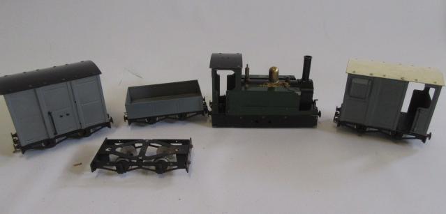 A live steam Mamod locomotive with body modification to tram type with four Mamod goods wagons Image