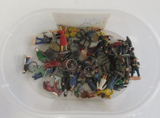 O-Scale railway figures including passengers and station staff Image