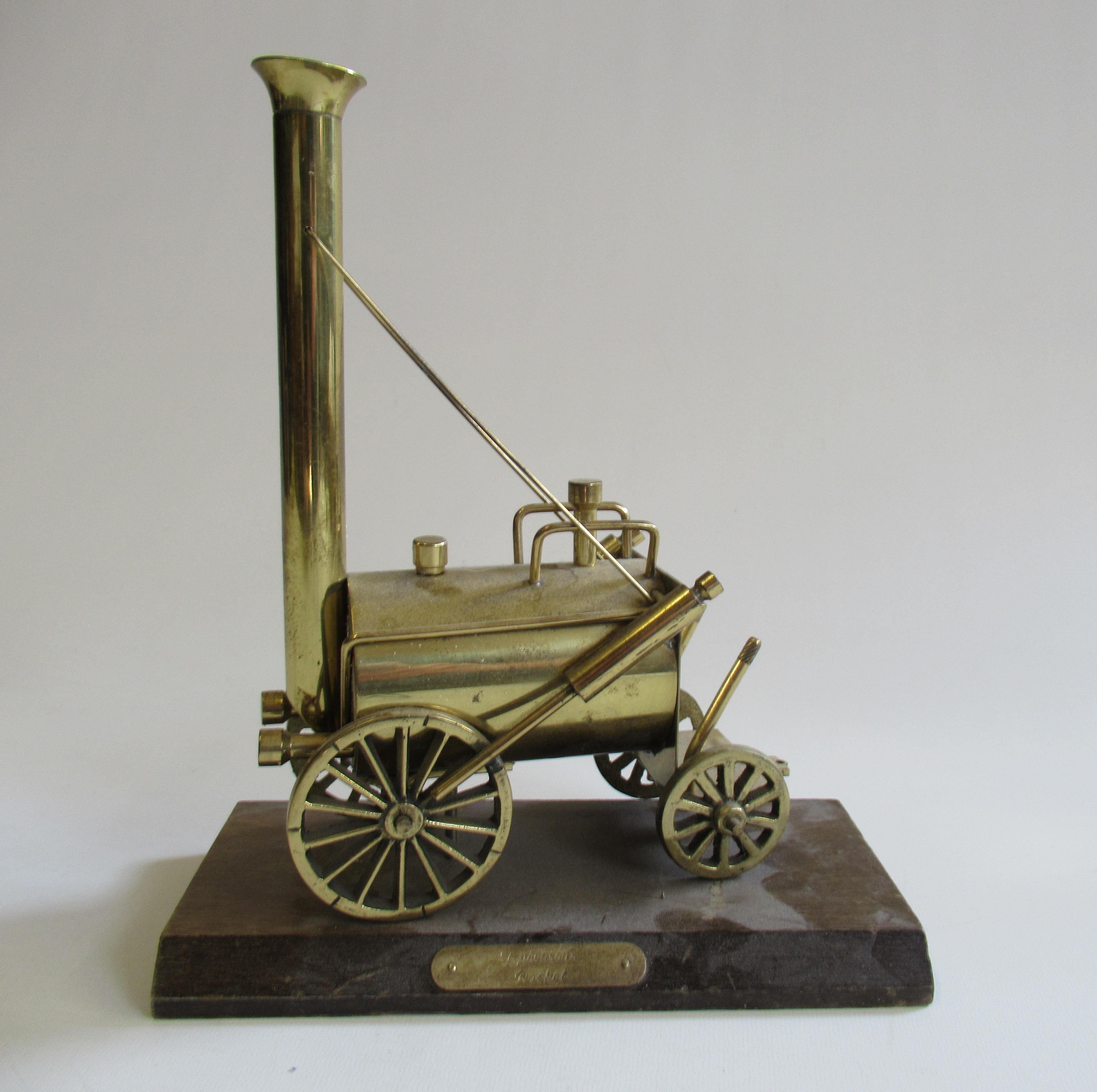 A brass stationary model of Stephenson's Rocket on wooden base with name plate Image