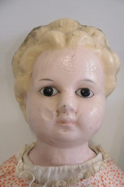 A moulded wax shoulder head doll Image
