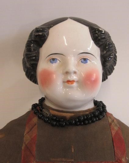 A moulded wax shoulder head doll Image