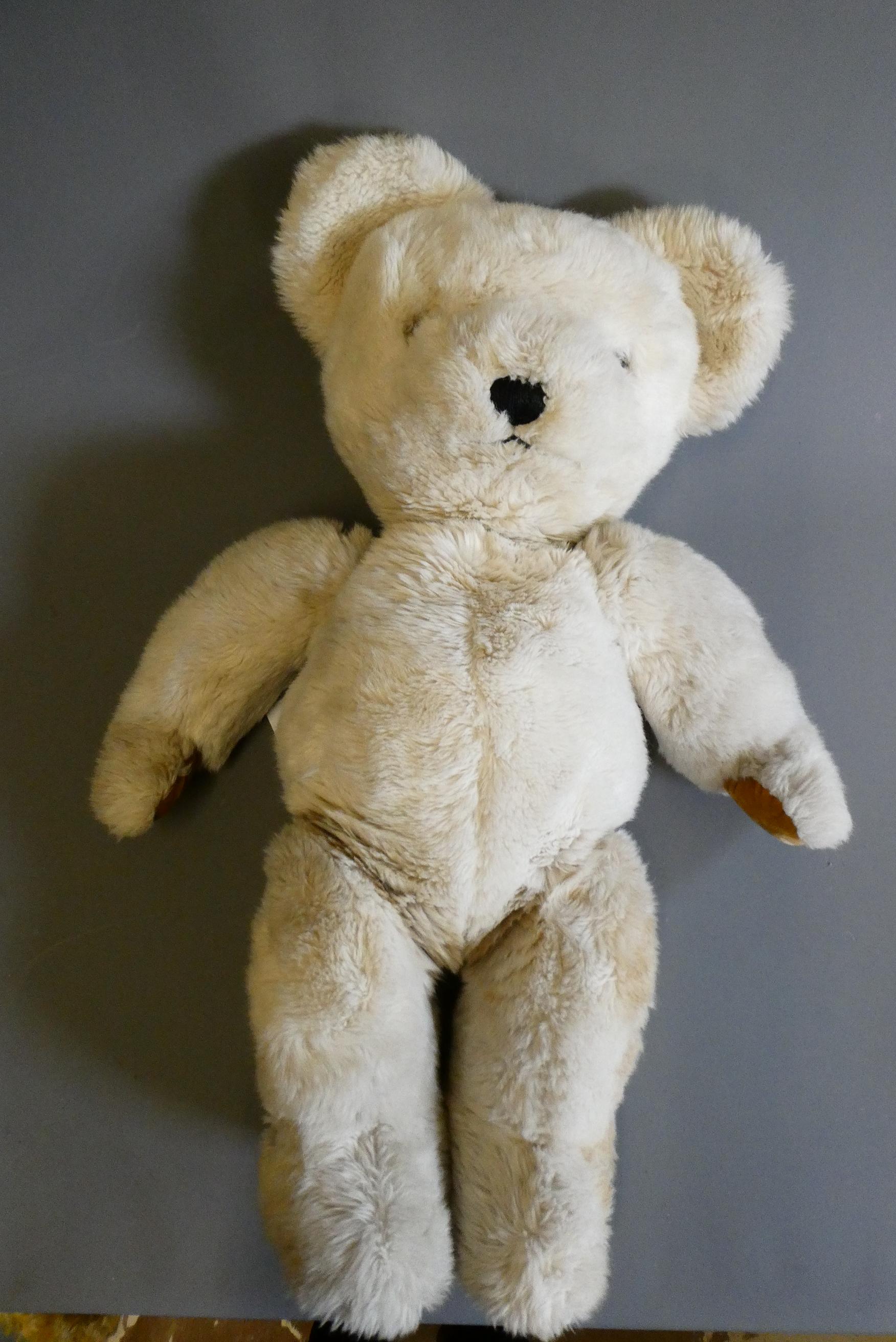 A large Merrythought white teddy bear, with clear glass eyes, sewn nose, felt pads and label, 33" Image