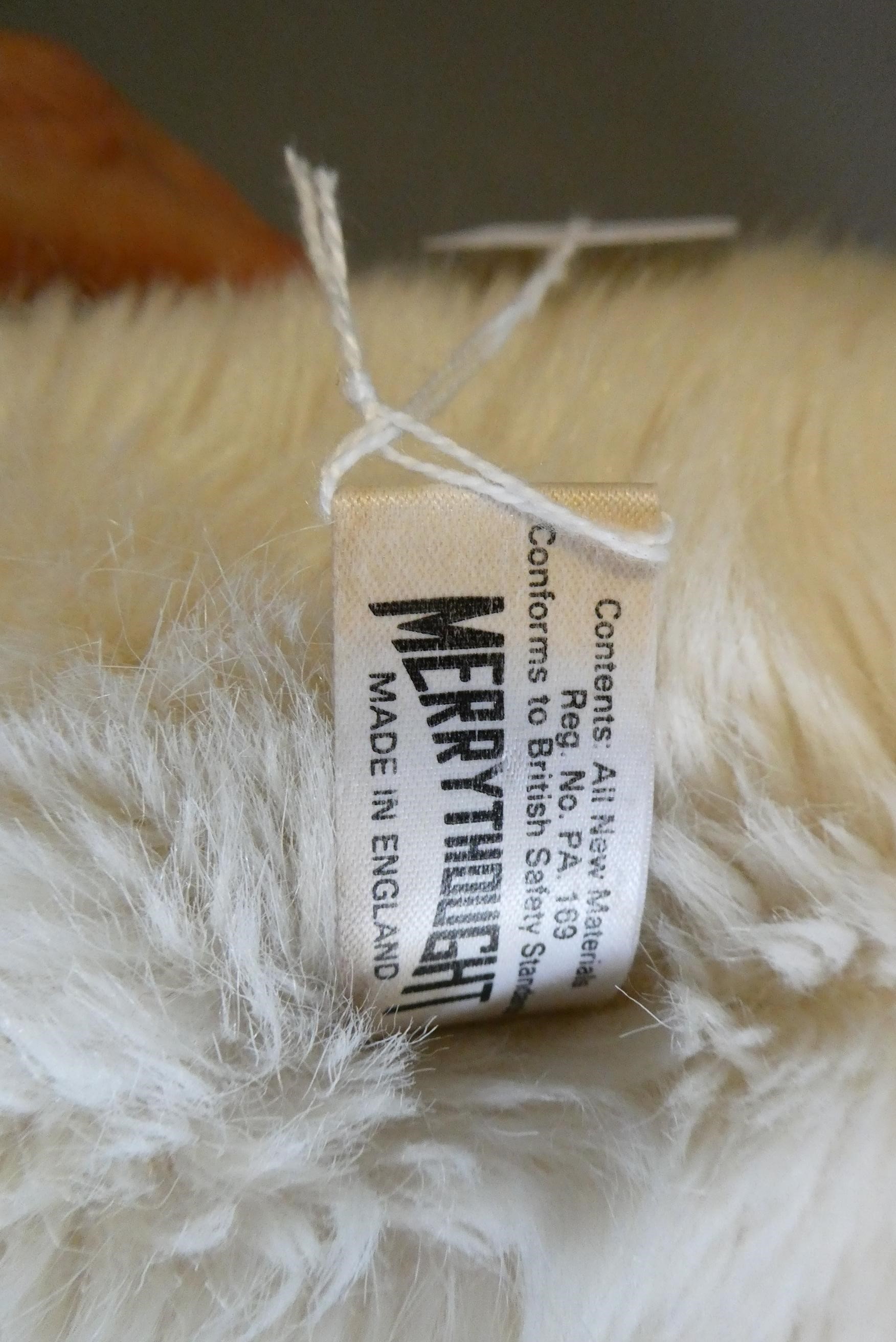 A large Merrythought white teddy bear, with clear glass eyes, sewn nose, felt pads and label, 33" Image