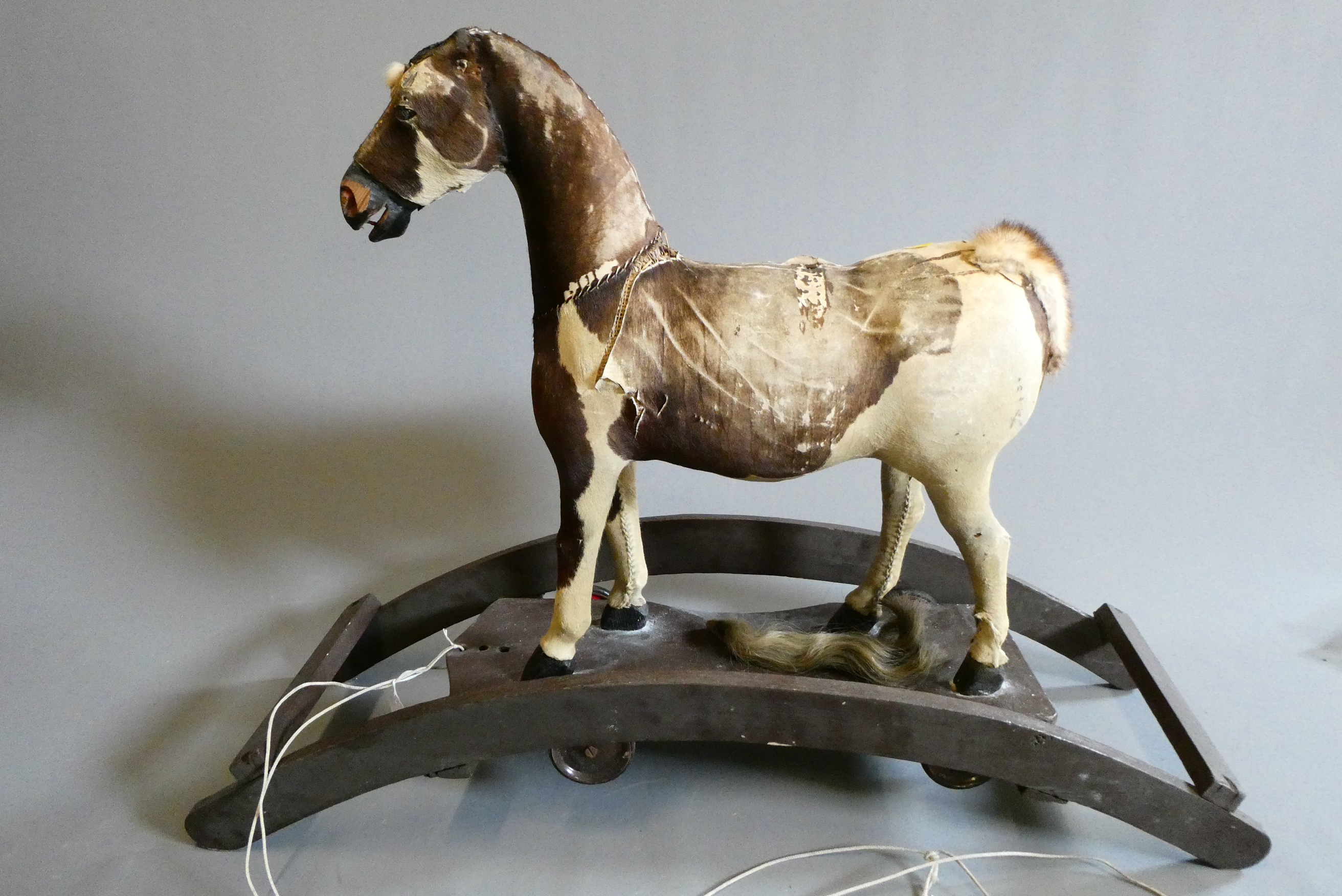 An antique pull-a-long rocking horse Image