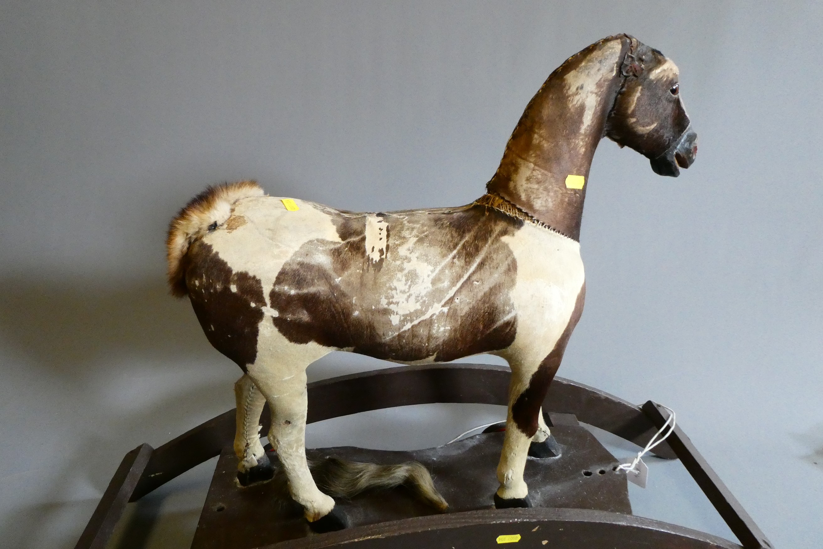 An antique pull-a-long rocking horse Image