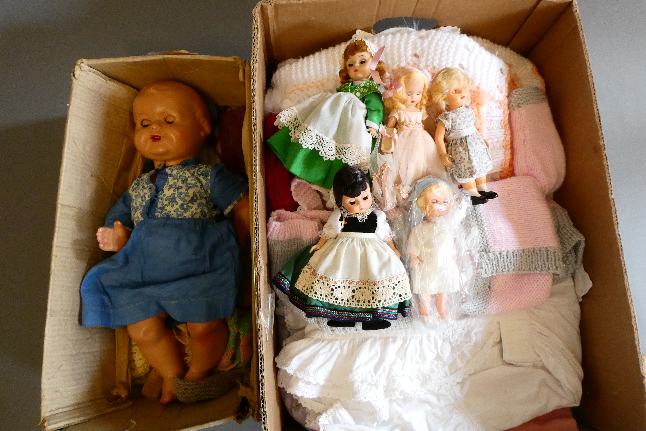 A collection of vintage dolls and clothing Image