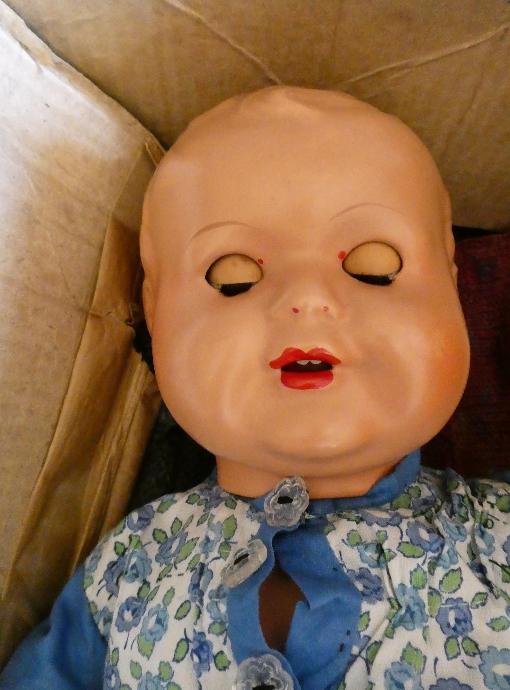 A collection of vintage dolls and clothing Image