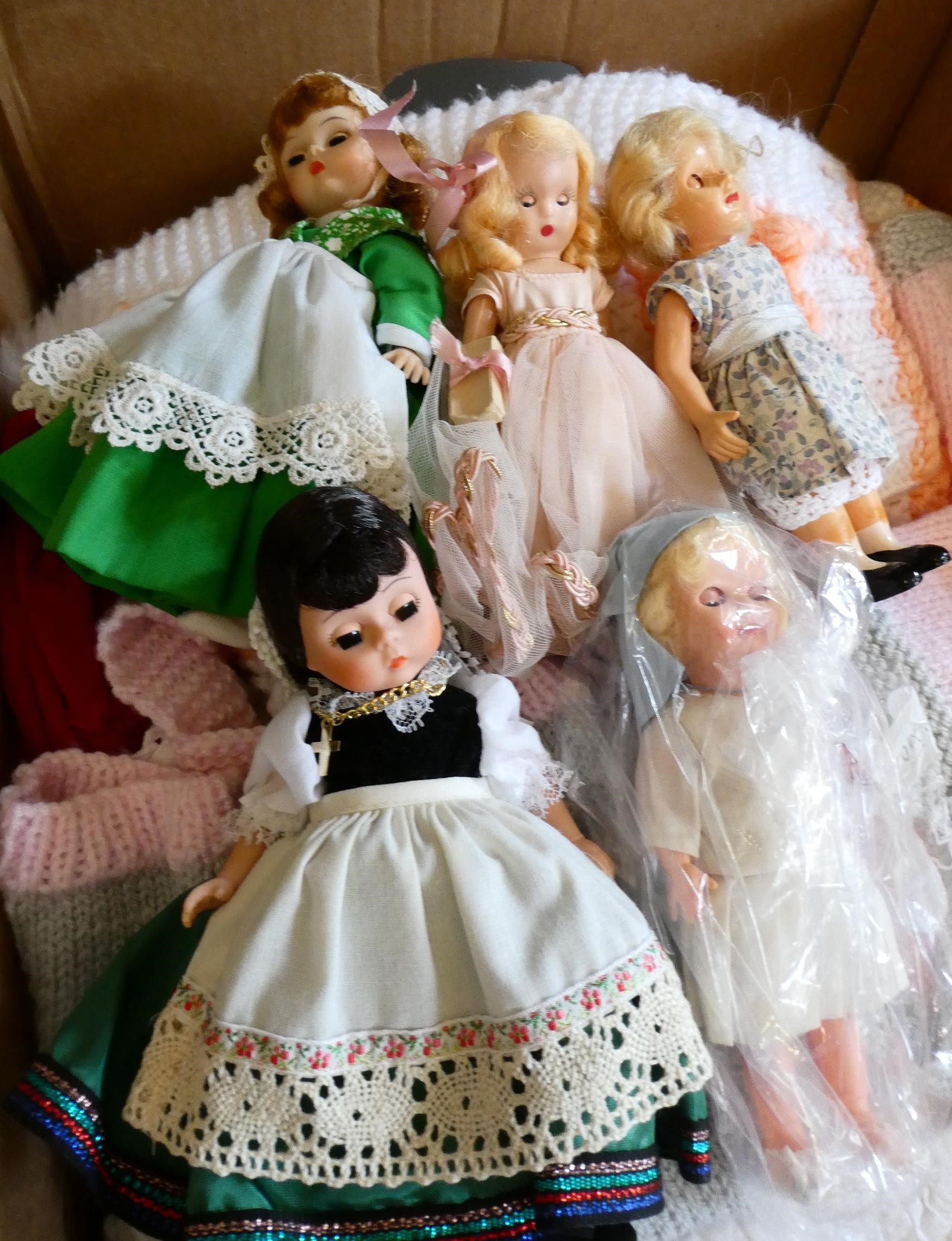 A collection of vintage dolls and clothing Image