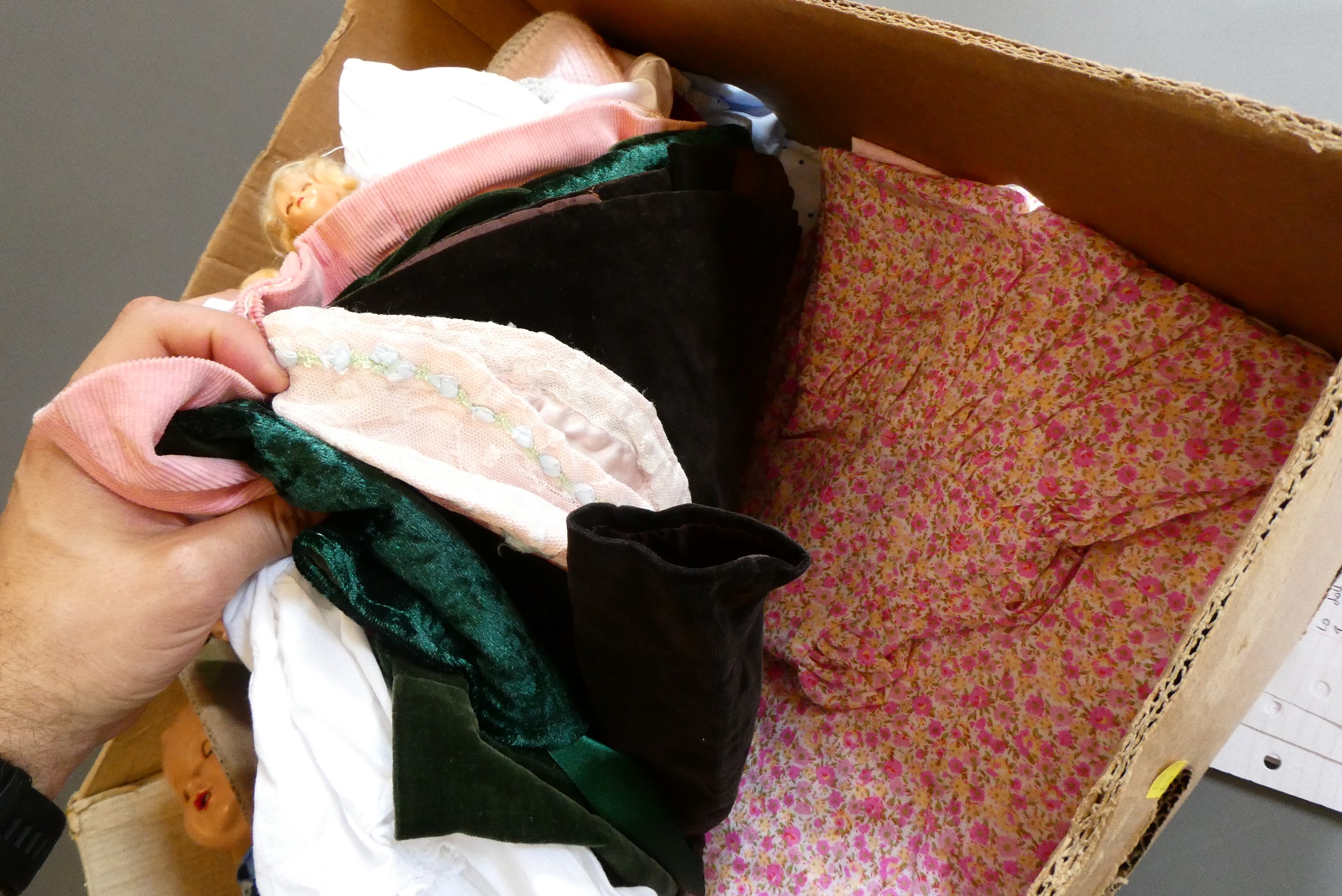 A collection of vintage dolls and clothing Image