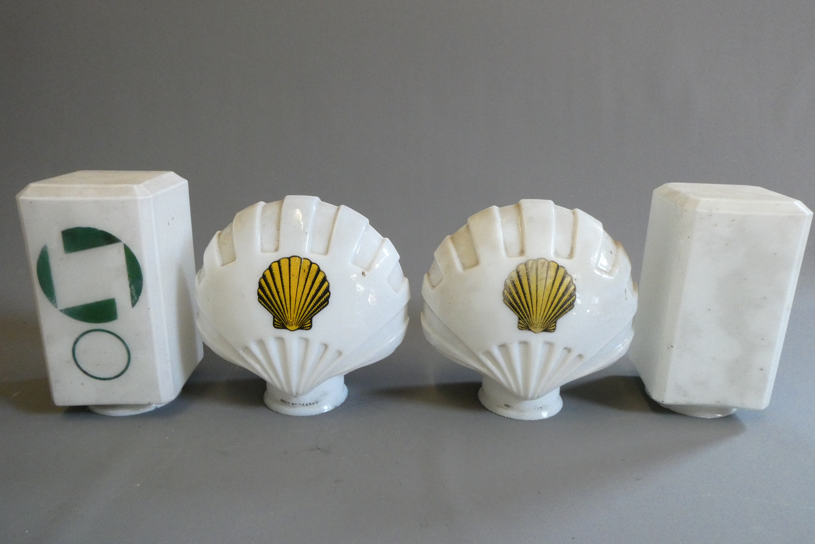 Four small petrol pump type glass globes, including two Shell examples, minor faults to three, Image