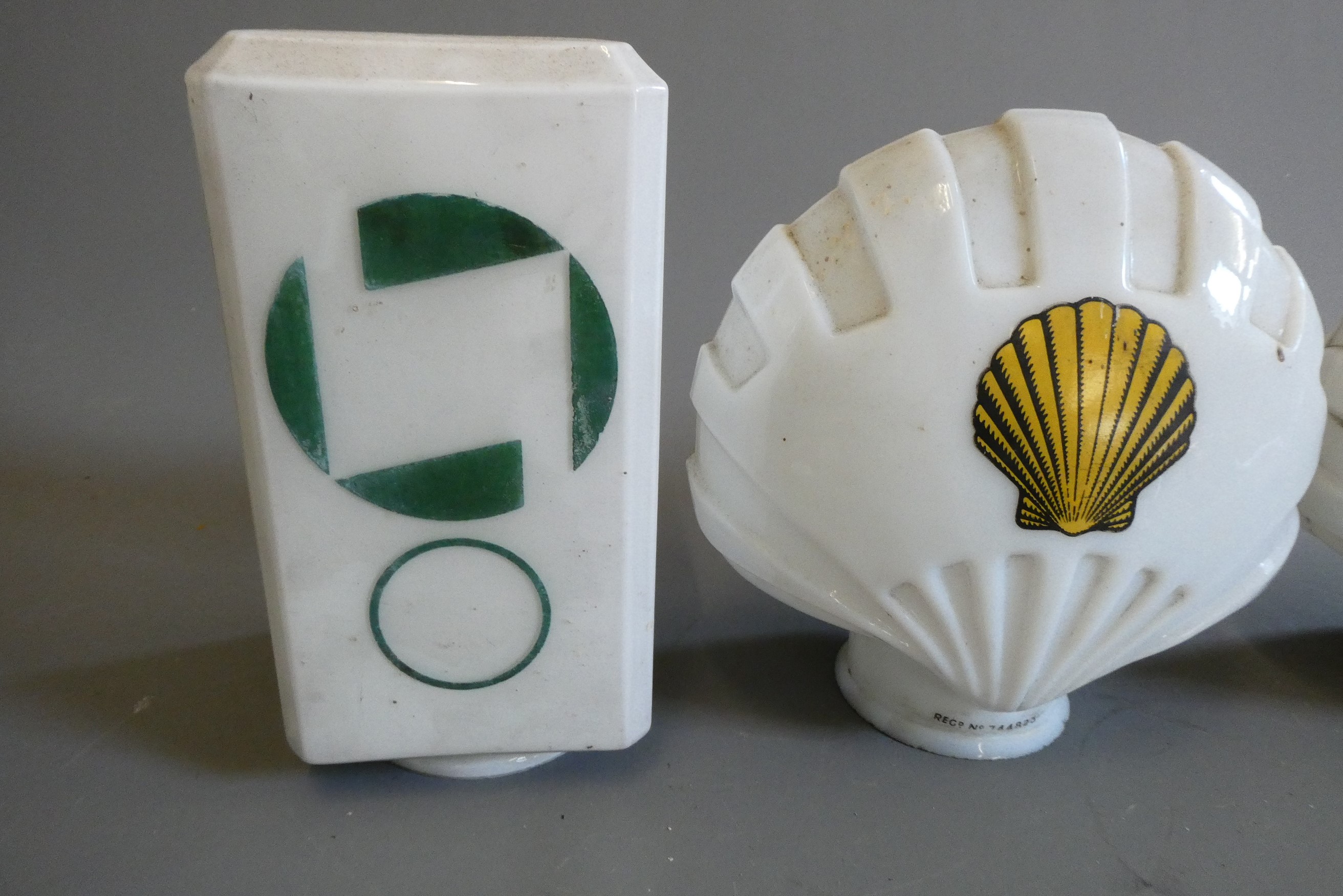 Four small petrol pump type glass globes, including two Shell examples, minor faults to three, Image