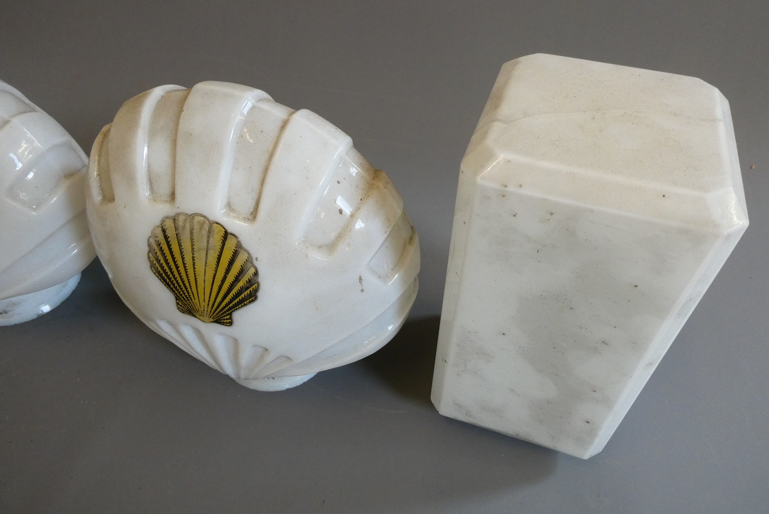 Four small petrol pump type glass globes, including two Shell examples, minor faults to three, Image