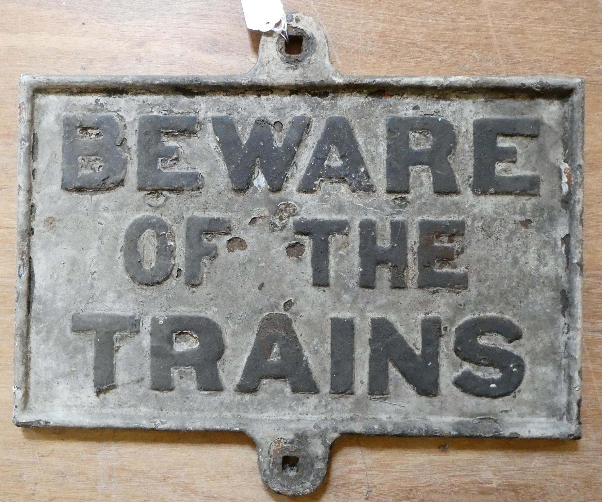 Cast "BEWARE OF THE TRAINS" sign, 18 3/4" x 15 3/4", oxidation and damage throughout (Est. plus 24% Image