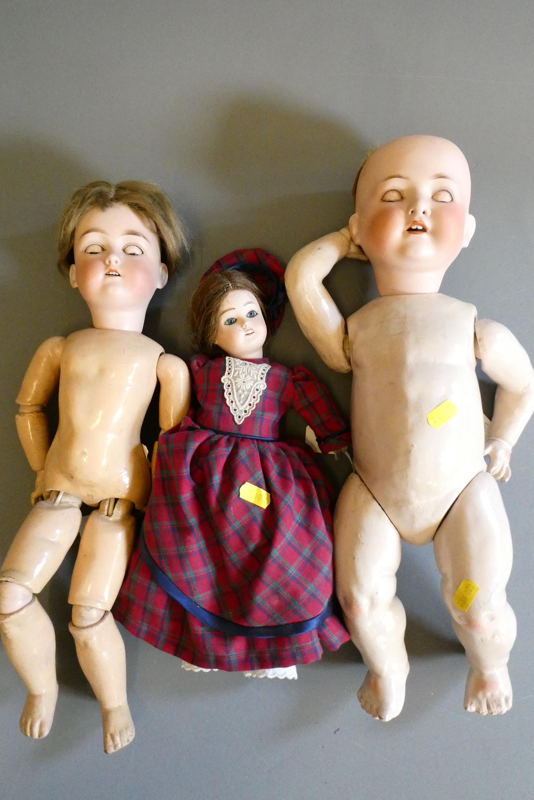 Three bisque socket head dolls comprising an 18" Heubach Koppelsdorf 320 3 doll with blue glass Image