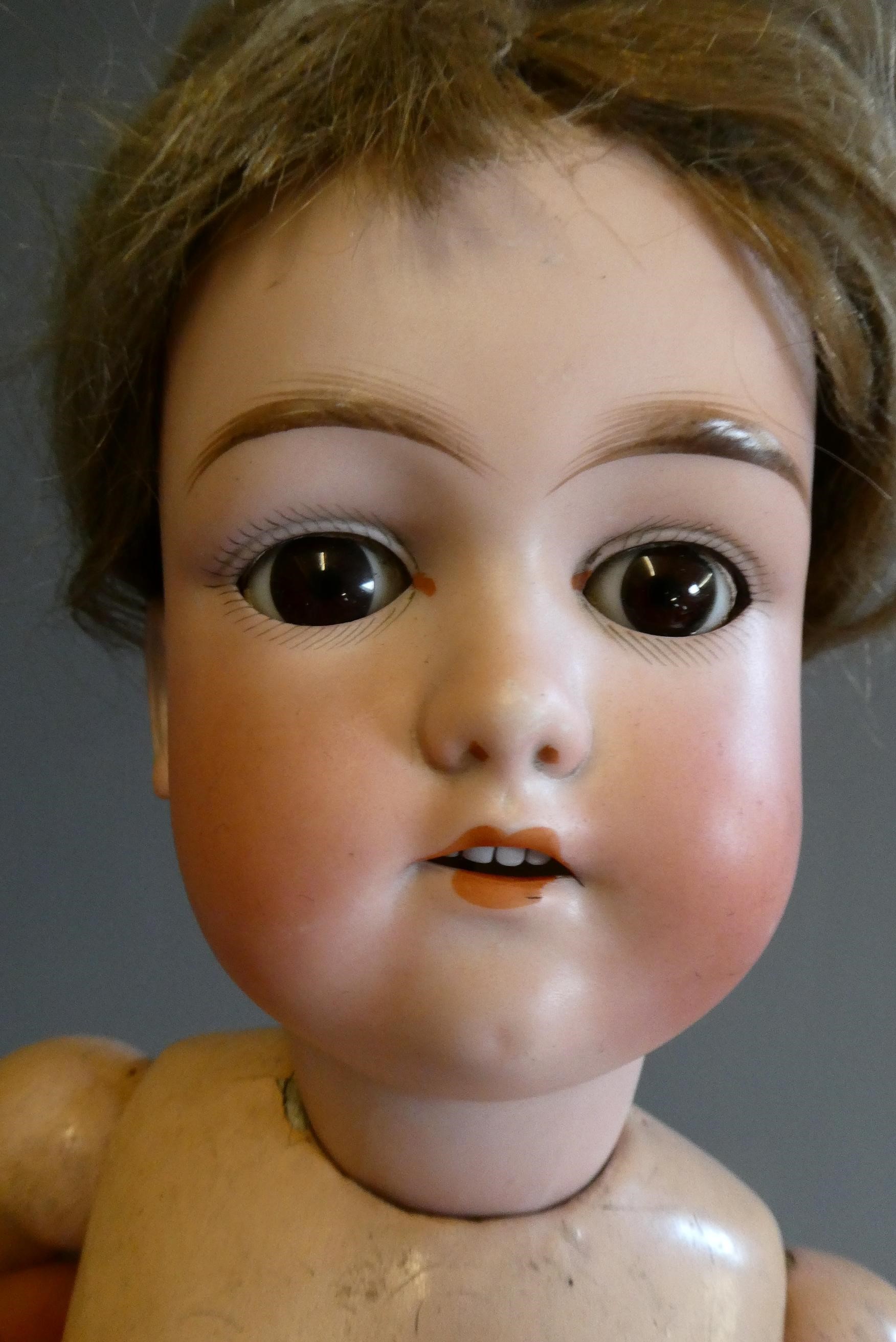 Three bisque socket head dolls comprising an 18" Heubach Koppelsdorf 320 3 doll with blue glass Image