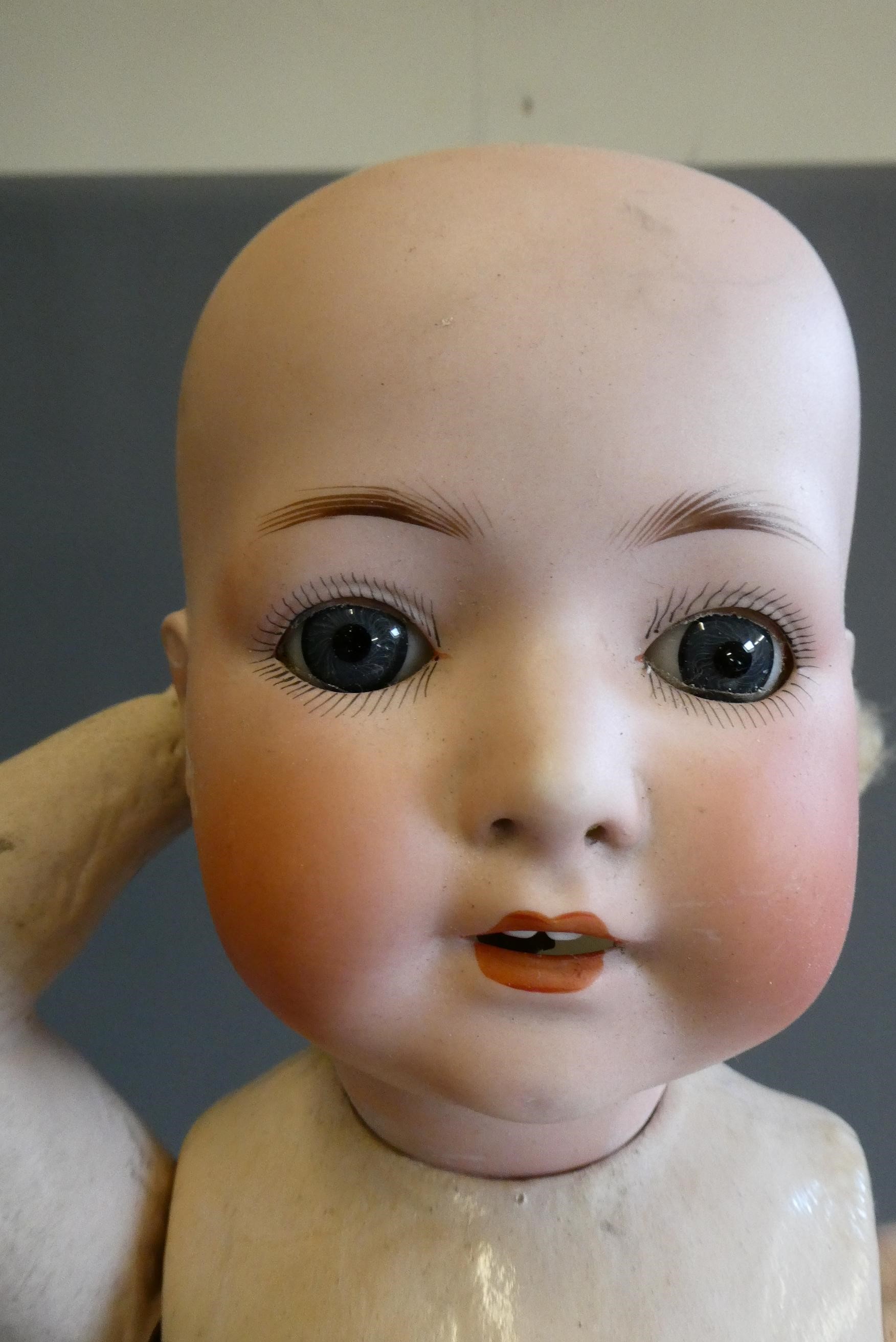 Three bisque socket head dolls comprising an 18" Heubach Koppelsdorf 320 3 doll with blue glass Image