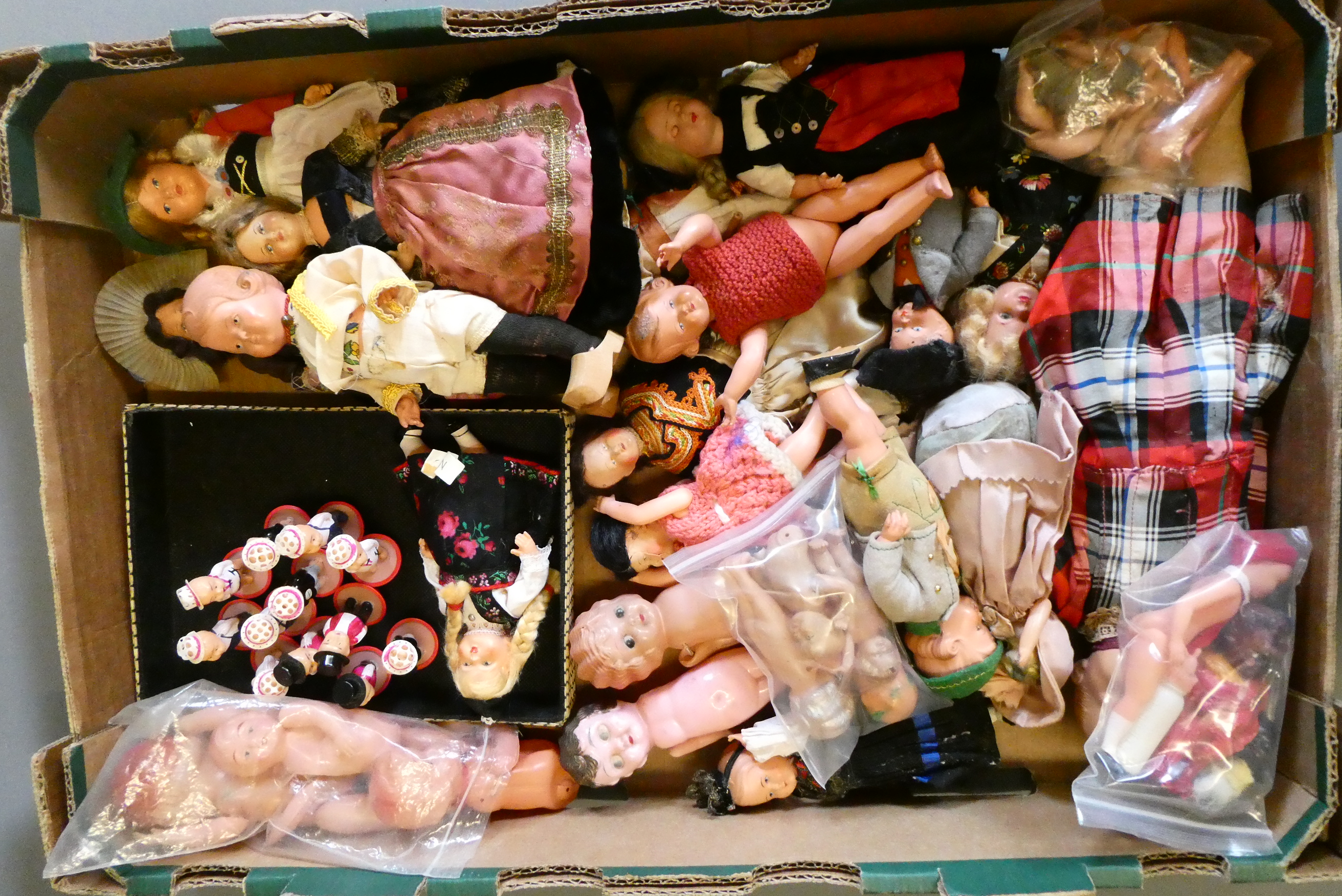 A collection of vintage celluloid dolls, including Roly Dolls, most in original dress (Est. plus 24% Image