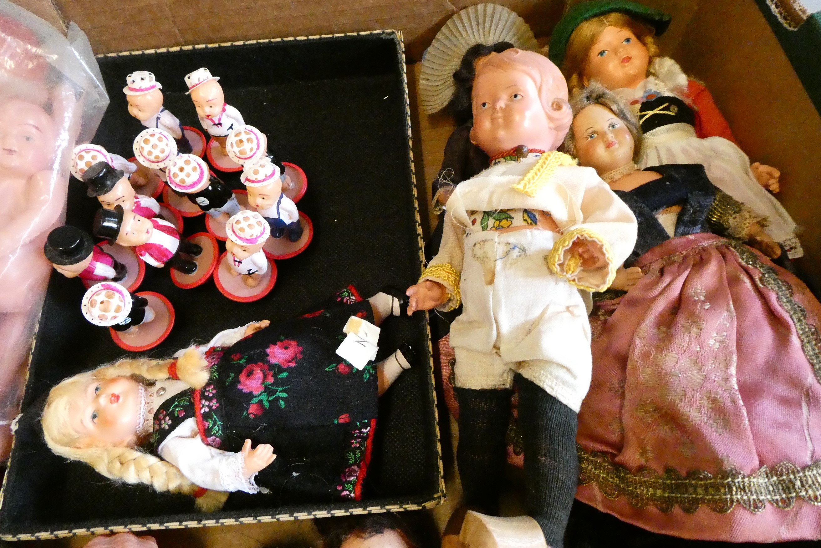 A collection of vintage celluloid dolls, including Roly Dolls, most in original dress (Est. plus 24% Image