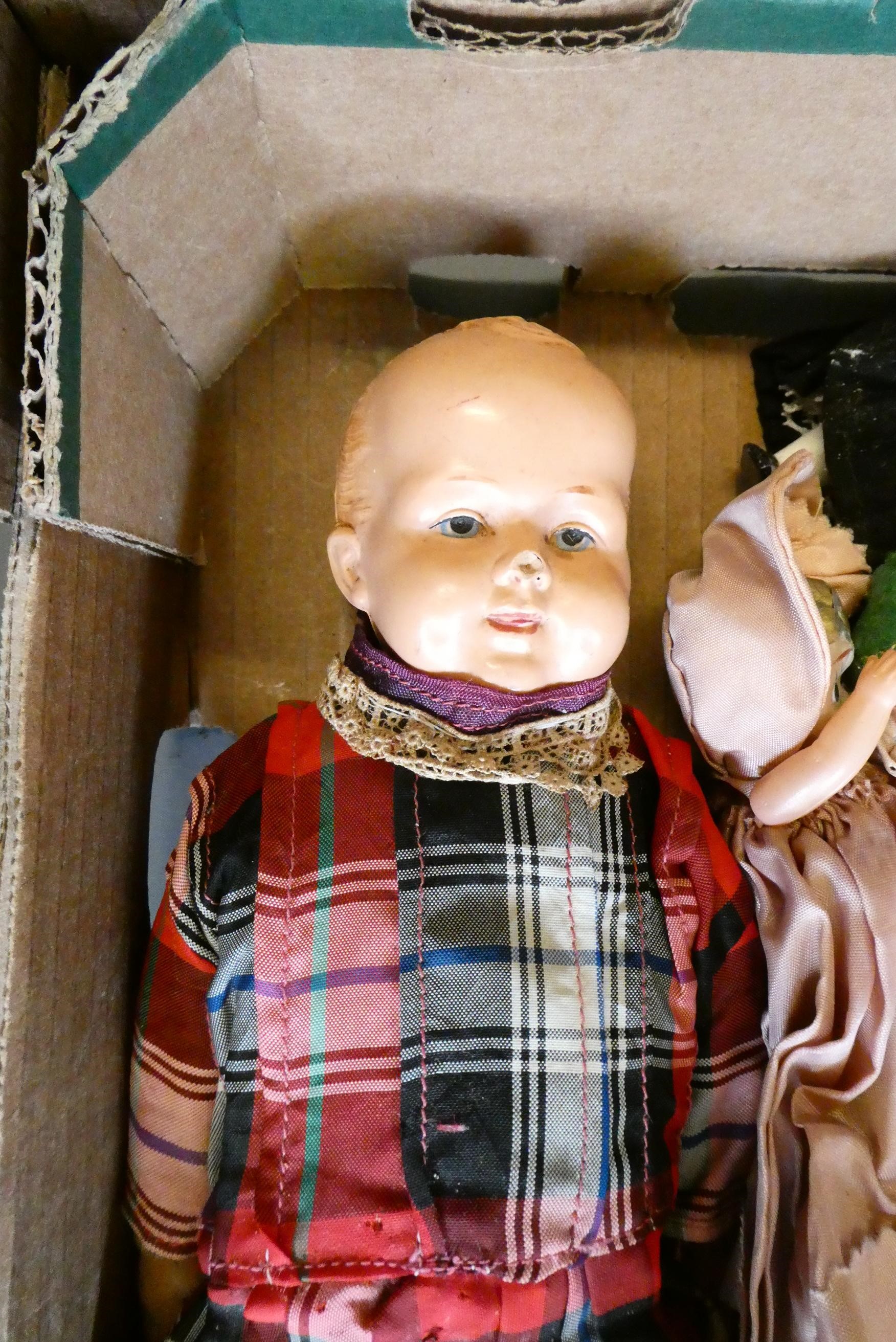 A collection of vintage celluloid dolls, including Roly Dolls, most in original dress (Est. plus 24% Image