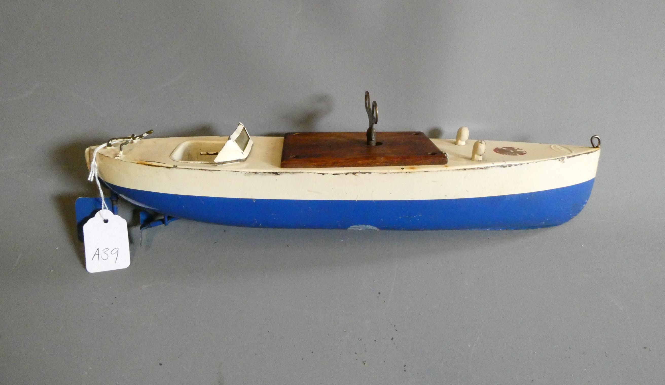 Sutcliffe models clockwork speed boat Meteor in blue and white, some minor paint and transfers loss. Image