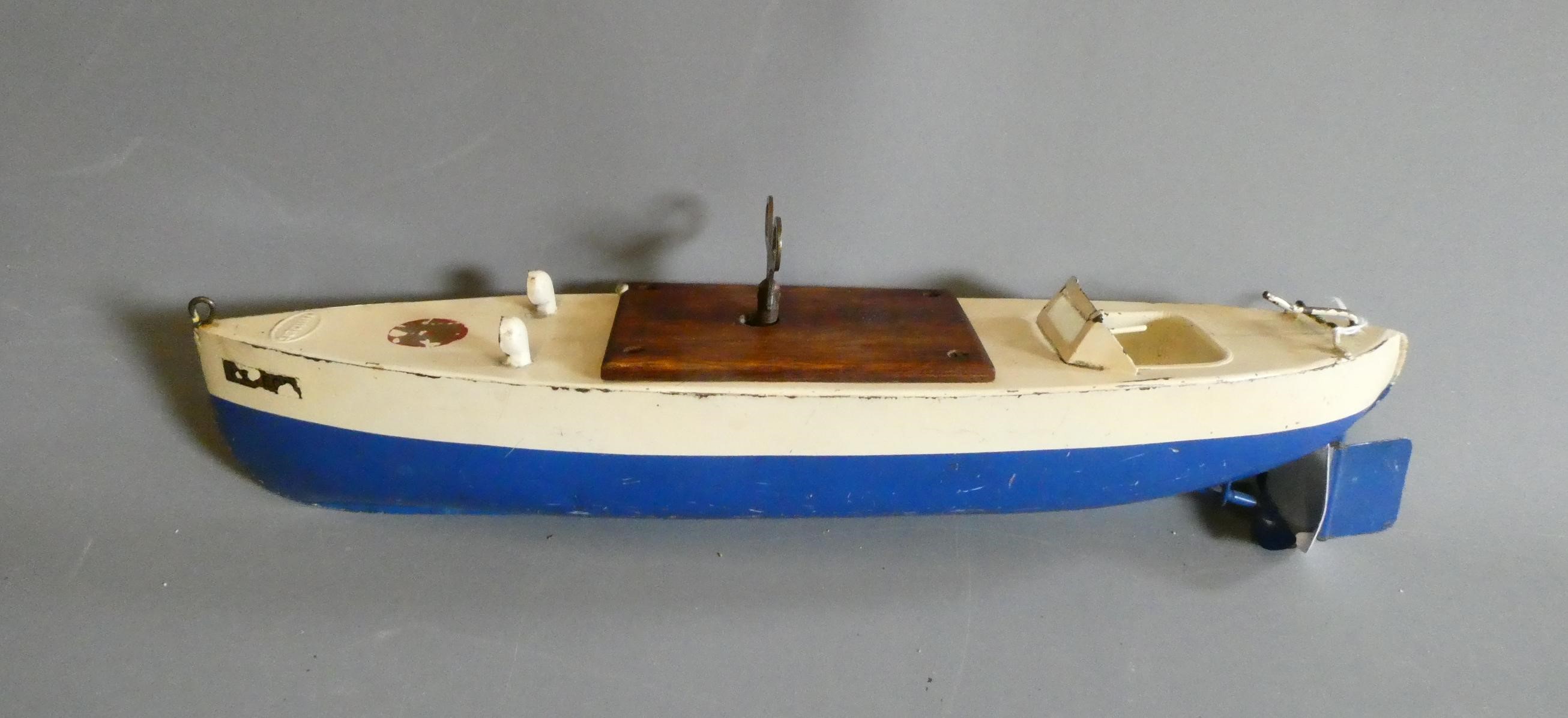 Sutcliffe models clockwork speed boat Meteor in blue and white, some minor paint and transfers loss. Image