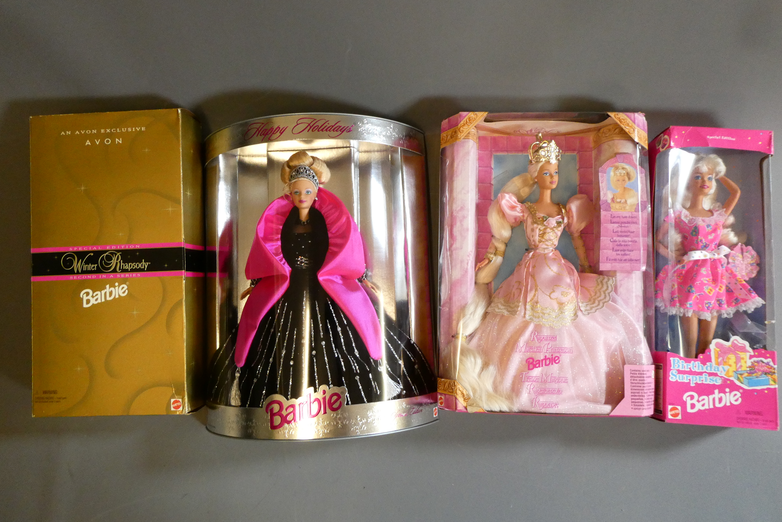 Four boxed Barbie dolls, comprising Special Edition Happy Holidays, Rapunzel, Winter Rhapsody Avon Image