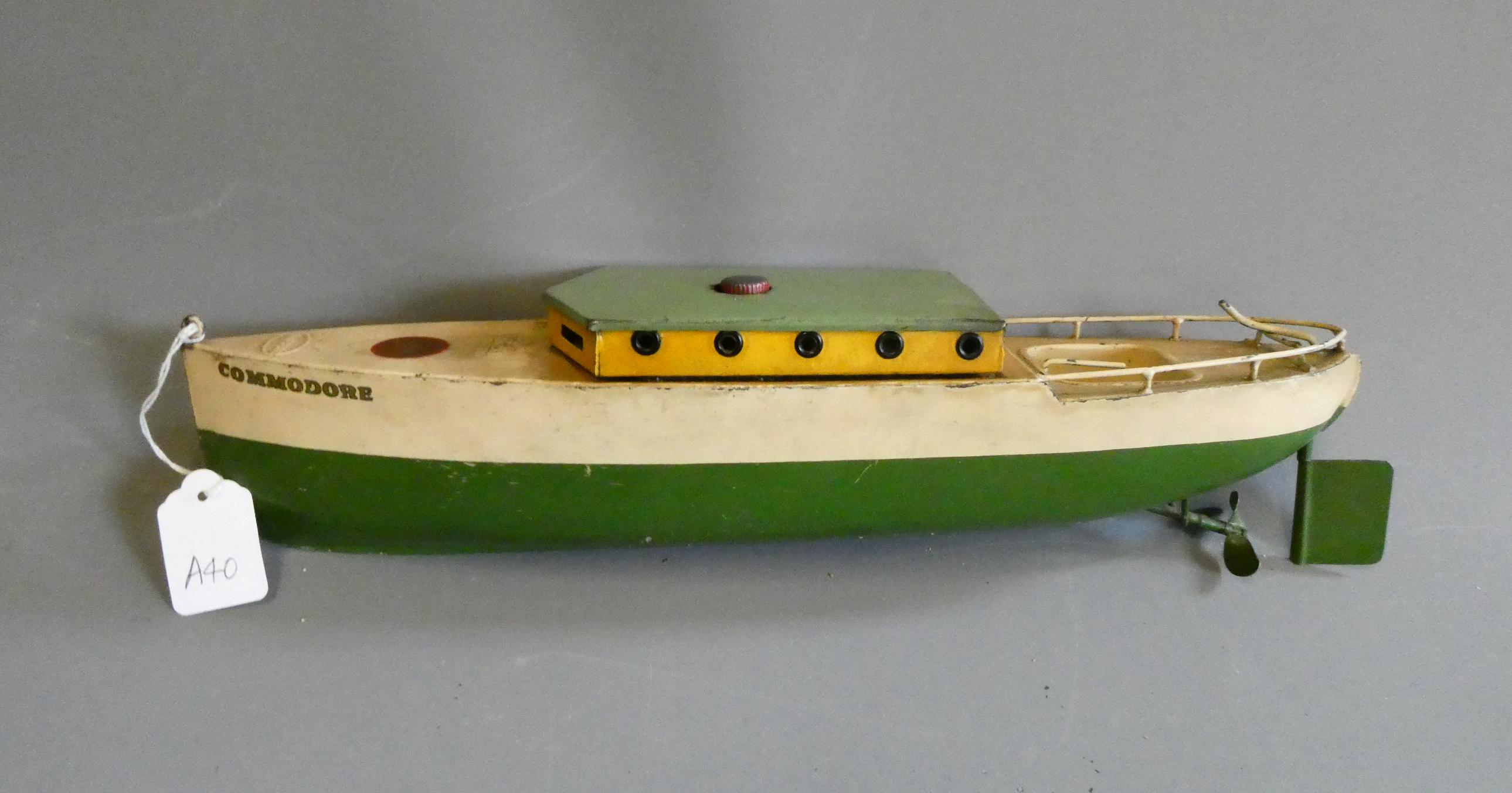 Rare Sutcliffe model clockwork cabin cruiser Commodore finished in green and cream. Clockwork motor Image