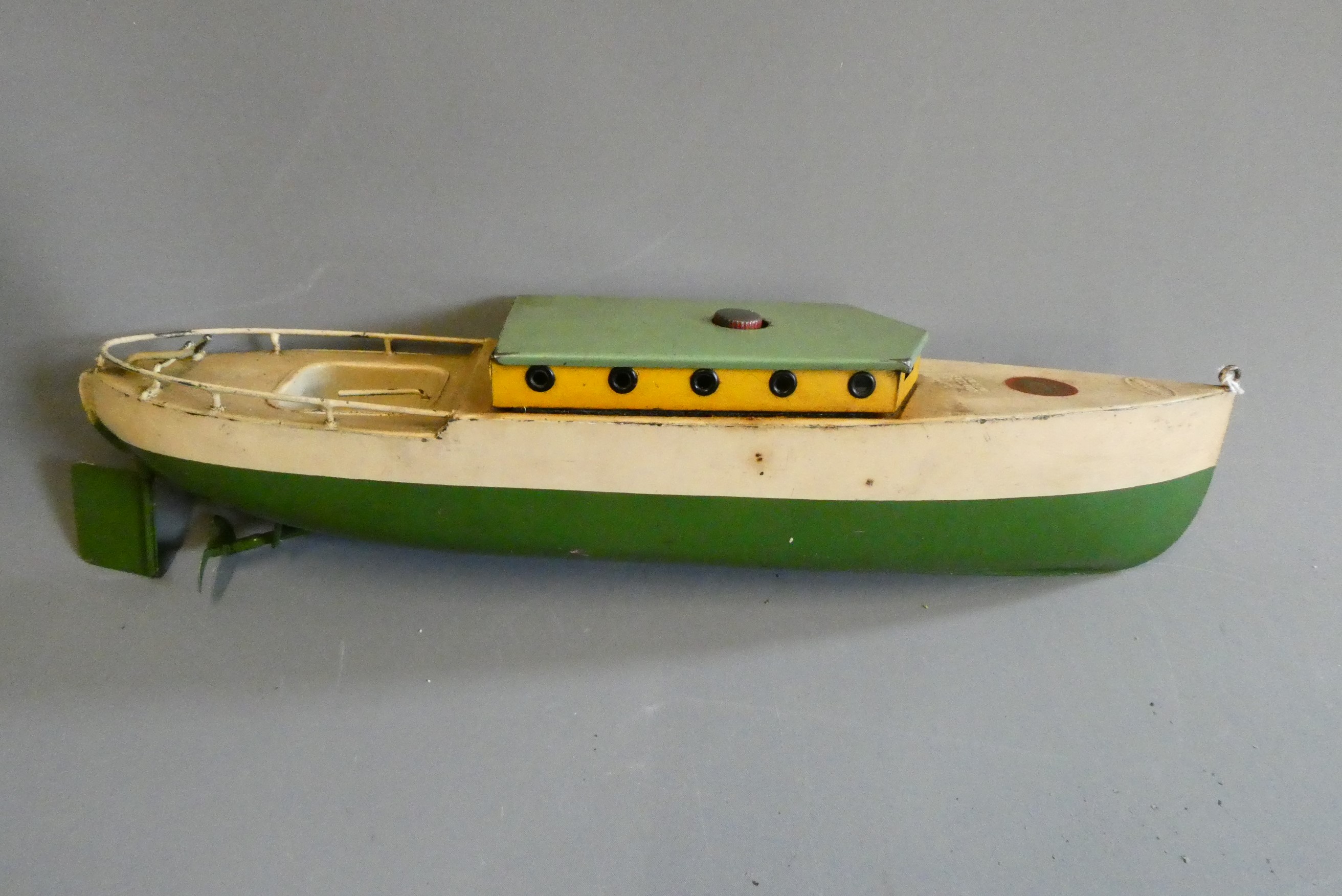 Rare Sutcliffe model clockwork cabin cruiser Commodore finished in green and cream. Clockwork motor Image
