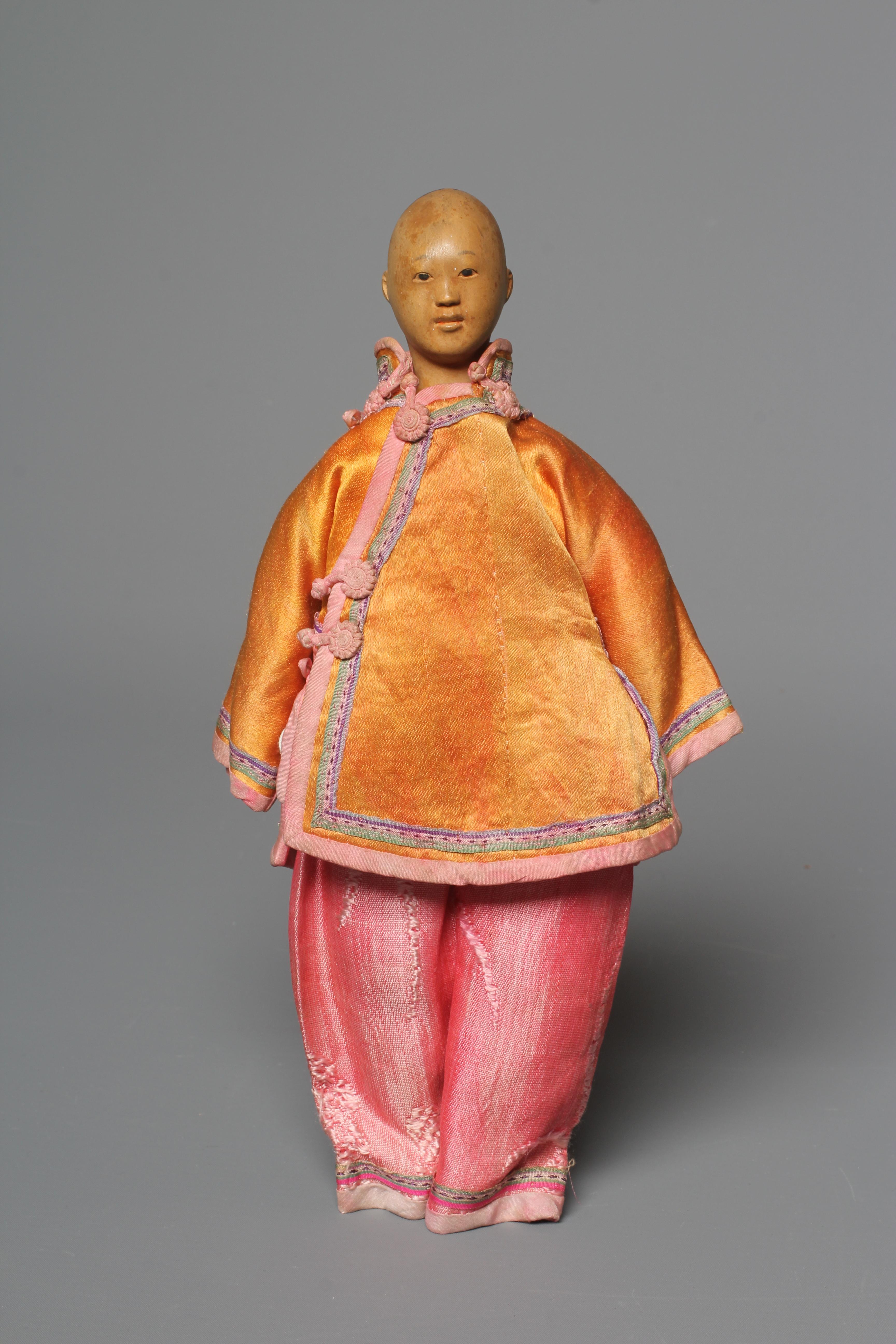 A Door of Hope male doll, with carved wood head, fabric body and original silk dress, 9 3/4" (Est. Image