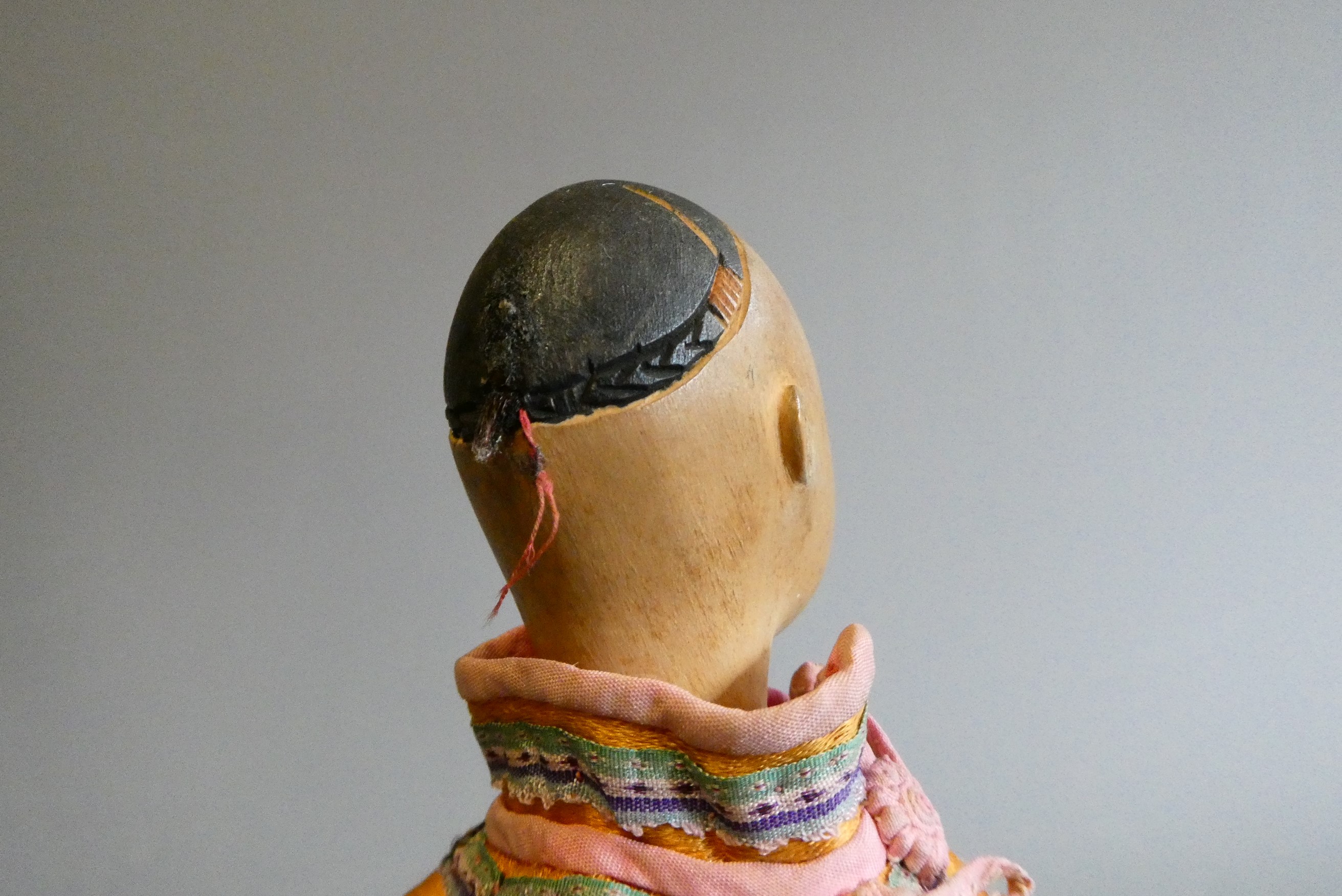 A Door of Hope male doll, with carved wood head, fabric body and original silk dress, 9 3/4" (Est. Image