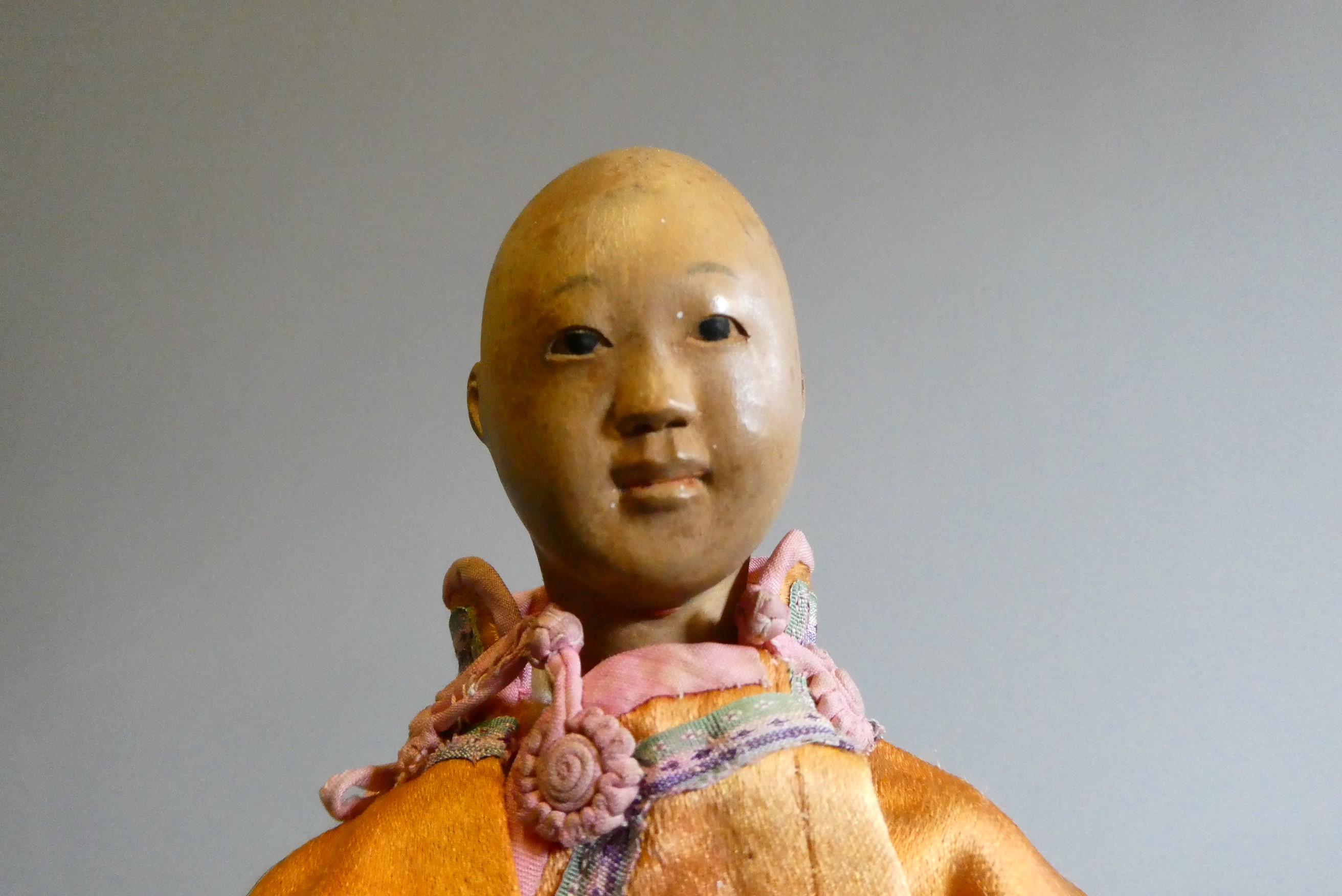 A Door of Hope male doll, with carved wood head, fabric body and original silk dress, 9 3/4" (Est. Image