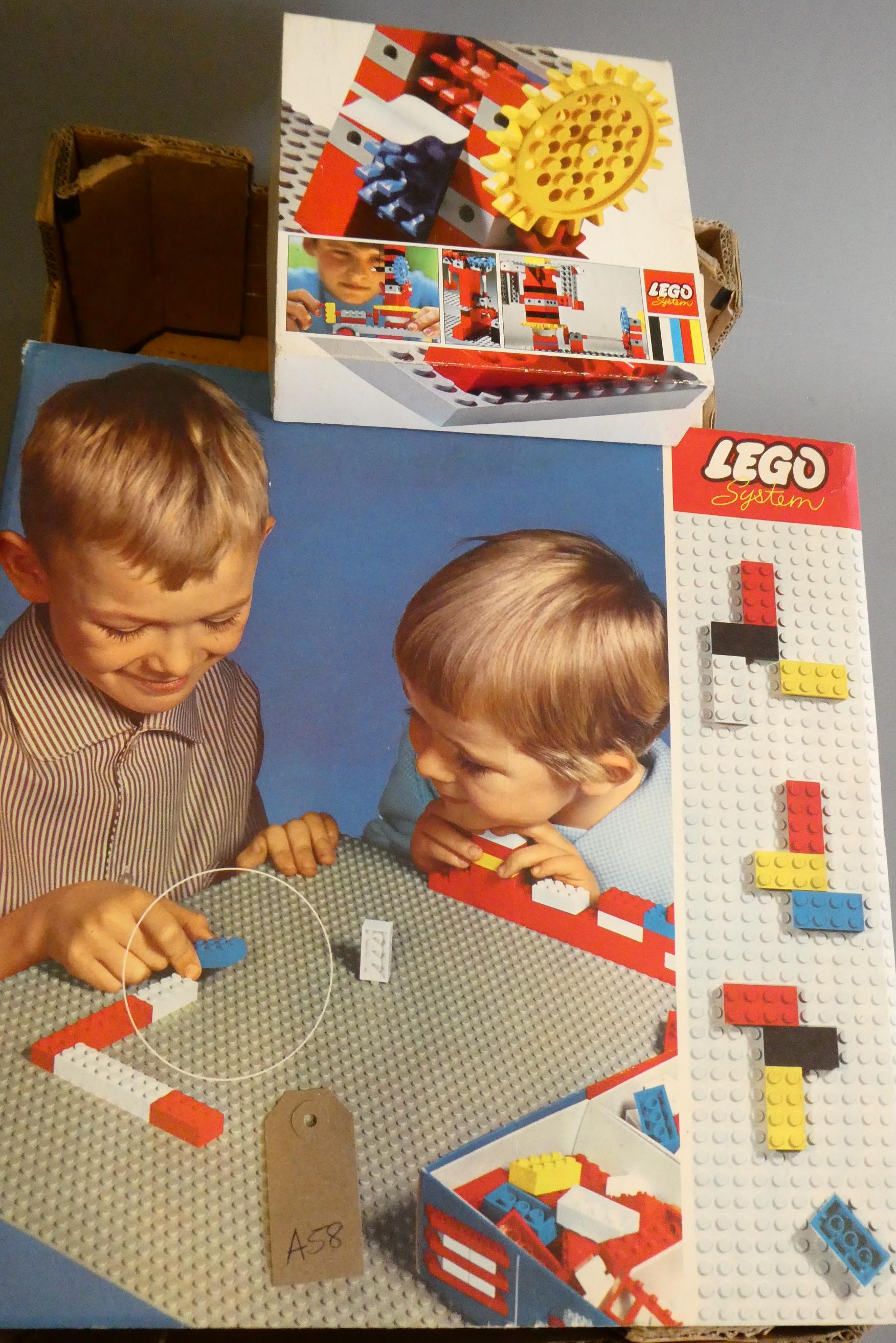 A large quantity of early Lego bricks and parts, some in original packing, others loose in box with Image