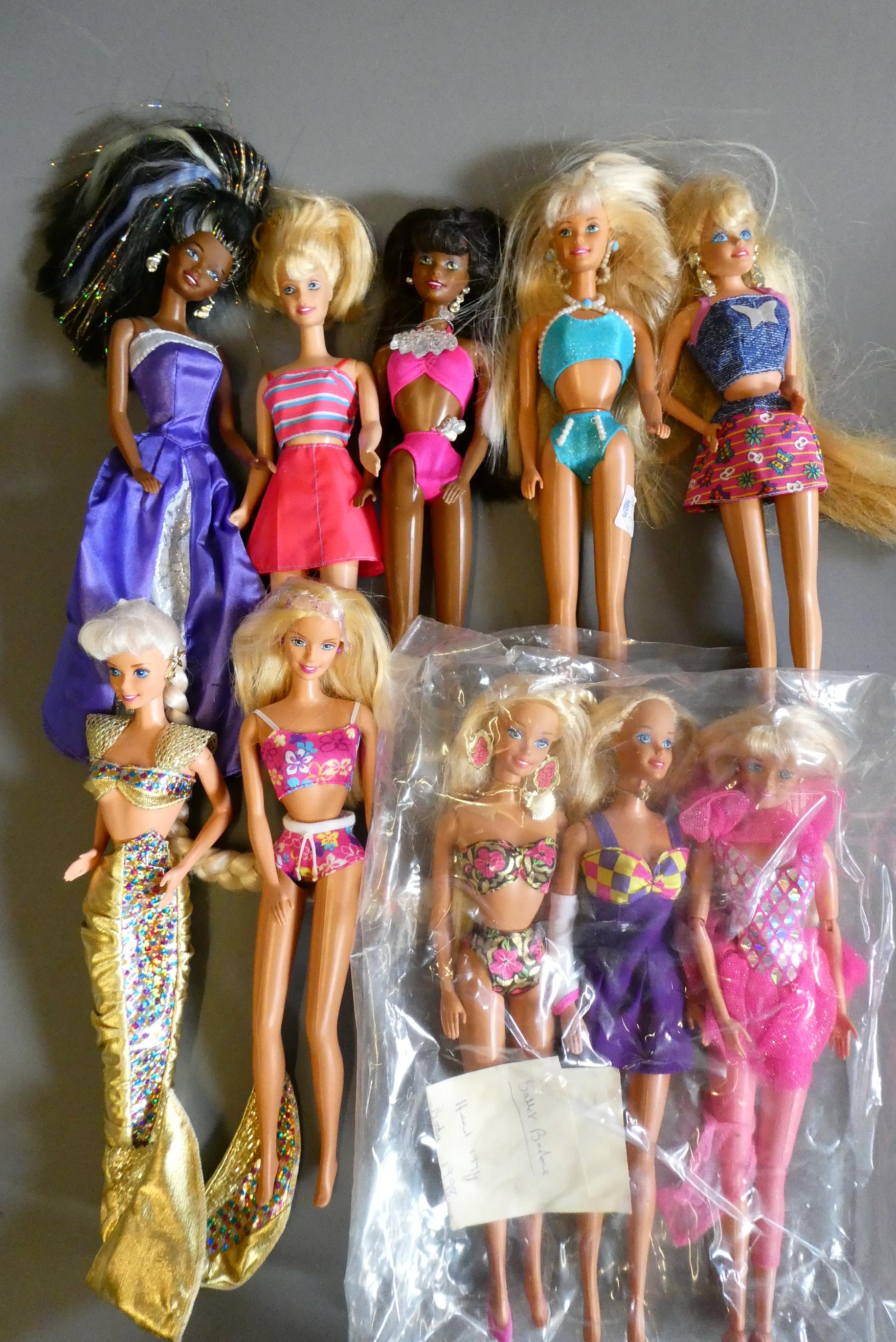 Ten Barbie dolls, including one fully jointed ballet Barbie and one with pull string spinning Image